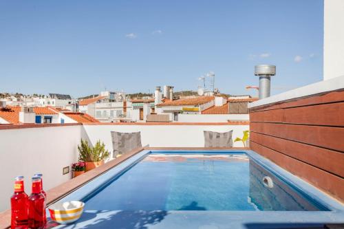 a swimming pool on the roof of a building at Bo&Co Apartments in Sitges