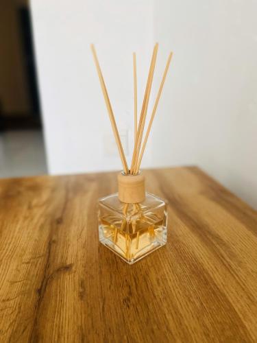 a glass vase with sticks in it on a table at 82 St Andrews Jackal Creek Golf Estate with Backup power & Golf course views in Roodepoort