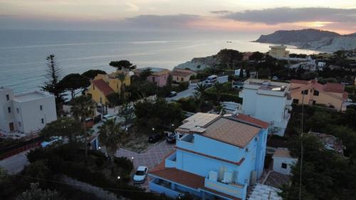 a view of a town with a blue house and the ocean at Villa Azzurra Scale of the Turks in Realmonte