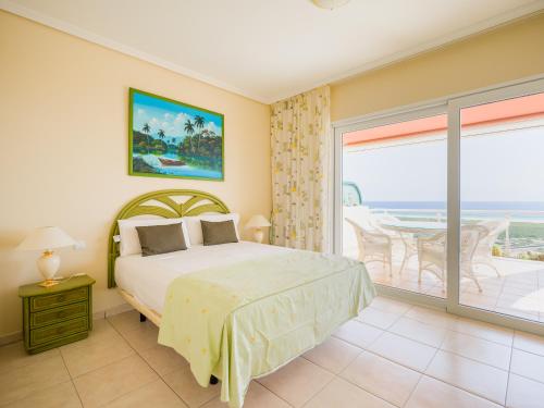 a bedroom with a bed and a view of the ocean at Mirador Balcón de Jandía in Morro del Jable
