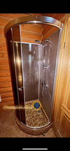 a shower with a glass enclosure in a bathroom at Moonglade Allure Houses in Polyana
