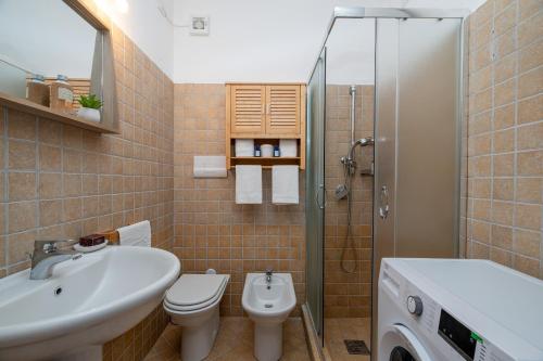 a bathroom with a sink and a toilet and a shower at Sunset Home in Costa Paradiso