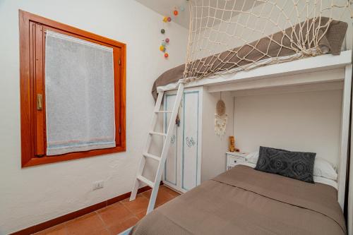 a bedroom with a bunk bed and a ladder at Sunset Home in Costa Paradiso