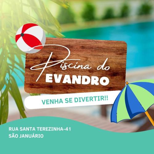 a sign with a beach ball and an umbrella next to a pool at Piscina Do Evandro in Campina Grande