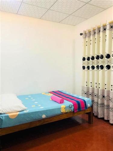 a room with a bed in a room with wine bottles at Talpe Inn in Unawatuna