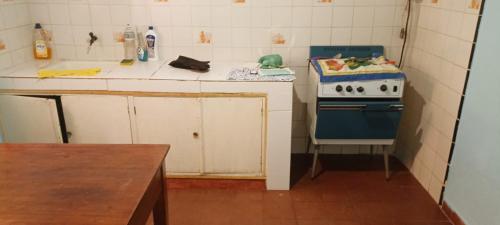 a small kitchen with a blue and white stove at Doña beba in Artigas