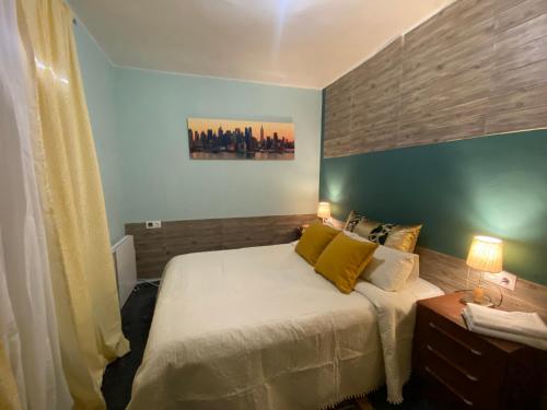 een slaapkamer met een groot bed met gele kussens bij LA CASA DE LAS HADAS in La Reguda