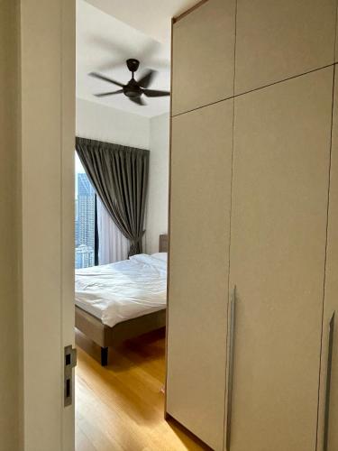 a bedroom with a closet and a bed with a ceiling at SS KL Sentral by NomadNest in Kuala Lumpur