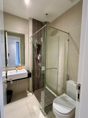 a bathroom with a shower and a toilet and a sink at SS KL Sentral by NomadNest in Kuala Lumpur