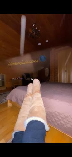 a persons leg laying on a bed in a room at Moonglade Allure Houses in Polyana