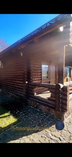 a log cabin with a window on the side of it at Moonglade Allure Houses in Polyana