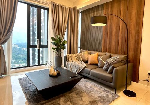 a living room with a couch and a table at SS KL Sentral by NomadNest in Kuala Lumpur