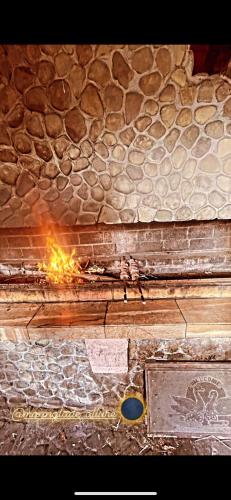 a person standing in front of a fire in a building at Moonglade Allure Houses in Polyana
