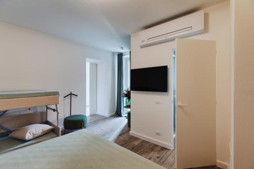 a bedroom with a bed and a flat screen tv at Villa "LE GILDA" 5 STELLE in Massa