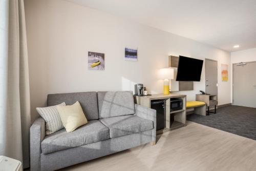 a living room with a couch and a television at Comfort Inn & Suites Gaylord in Gaylord