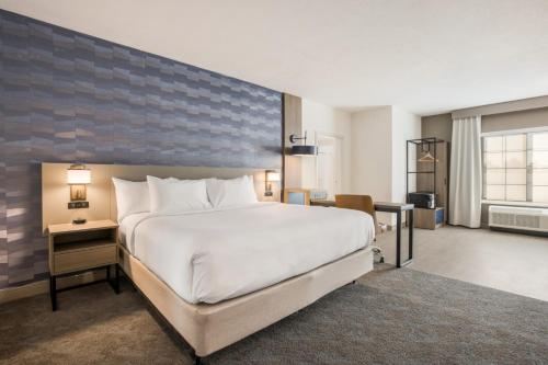 a bedroom with a large white bed and a desk at Comfort Inn & Suites Gaylord in Gaylord