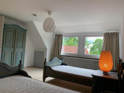 a bedroom with two beds and a window at Nordseehaus Muschel in Dornum