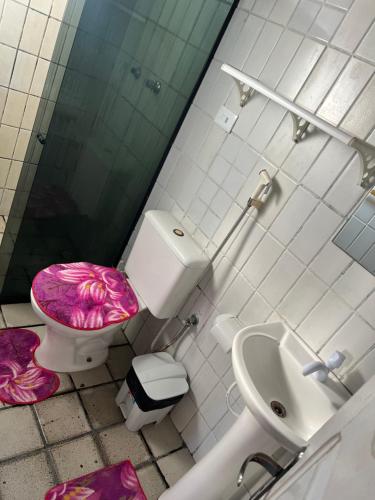 a bathroom with a toilet and a sink at Village Gales Prive Maragogi in Maragogi