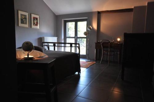 a living room with a bed and a table and a dining room at beppe country house in Asti