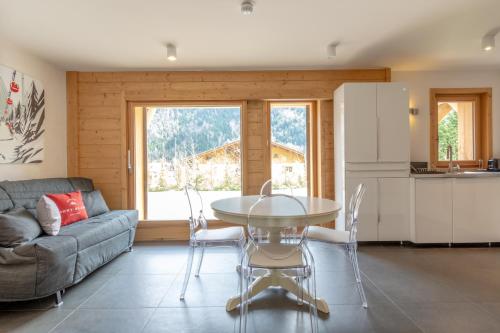a living room with a table and a couch at Chalet Caméline in Les Contamines-Montjoie
