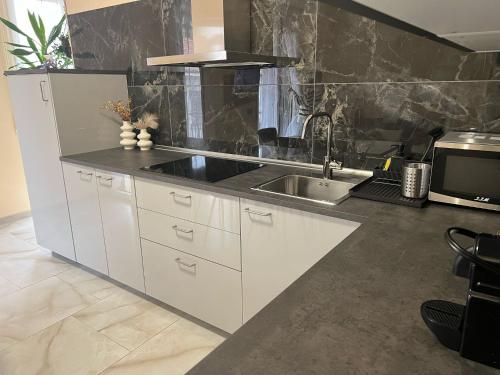 a kitchen with white cabinets and a sink at casa Hanna2 in Intra