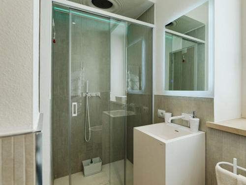 a bathroom with a glass shower and a sink at Villa "LE GILDA" 5 STELLE in Massa