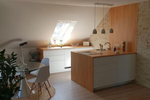 a kitchen with a sink and a table with chairs at FeWo-Heidekreis right along the old river Leine in Ahlden