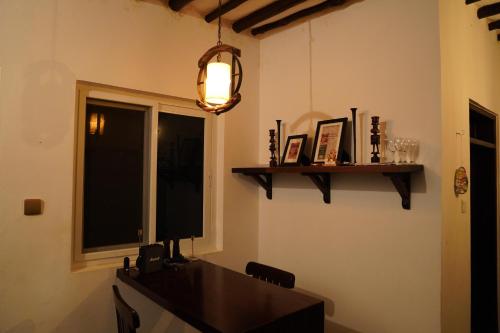 a dining room with a table and a window at Ring Residence Guesthouse in Diani Beach