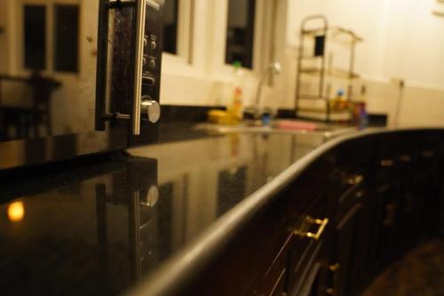 a kitchen with a counter top with rain on it at Ring Residence Guesthouse in Diani Beach