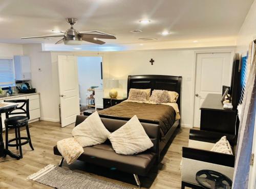a bedroom with a bed and a couch and a kitchen at Serenity home in Laplace