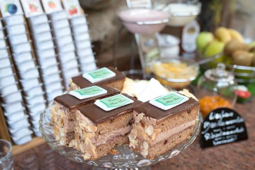 a plate with several pieces of cake on a table at Pension Haus Sanz in Vienna