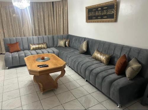 ein Wohnzimmer mit einem Sofa und einem Couchtisch in der Unterkunft Appartement centre Agadir in Agadir