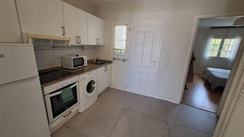 una cocina con fregadero y microondas. en Precioso apartamento en Playa Bastián en Costa Teguise