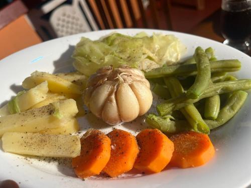 a plate of food with carrots and vegetables on a table at Thisha Hotel & Restaurant in Jaffna