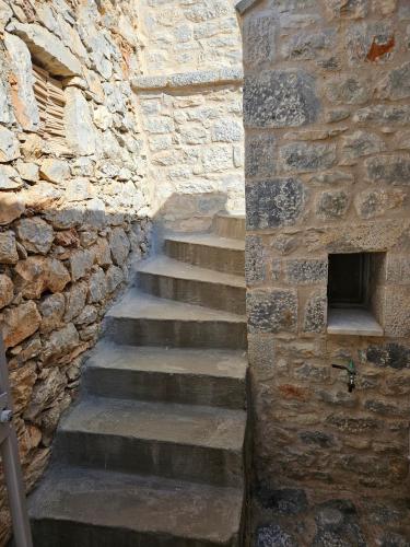 a stone stairway in a stone wall at Rigas stone tower east Mani 1 in Mína