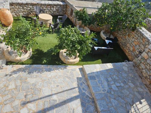 an aerial view of a garden with trees and chairs at Rigas stone tower east Mani 1 in Mína