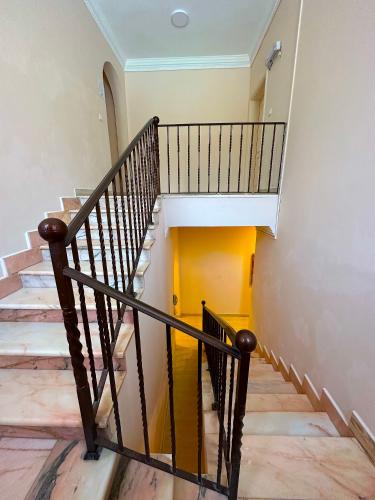 a spiral staircase in a home with wooden floors at منتجع داري الهدا in Al Hada