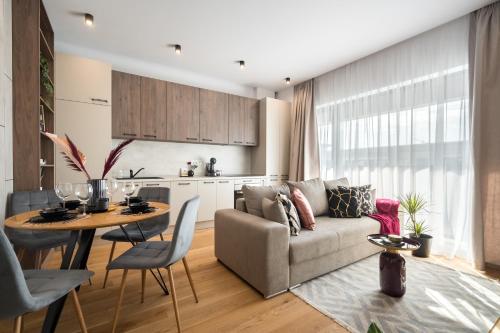 a living room with a couch and a table at Cozy Business Area 1BR near Aviatiei in Bucharest