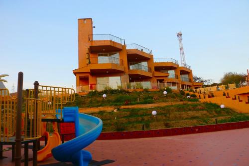 a playground with a slide in front of a building at منتجع داري الهدا in Al Hada