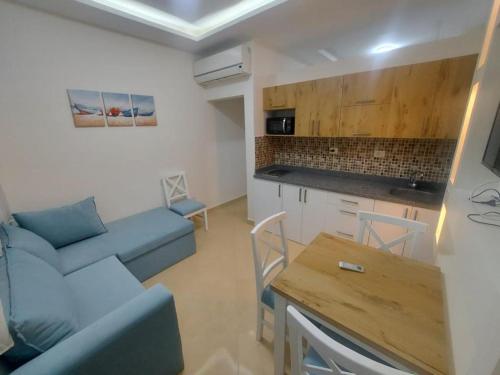 Sharm Hills Resort في شرم الشيخ: غرفة معيشة مع أريكة زرقاء وطاولة