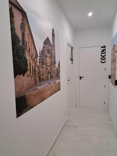 a hallway with a painting on the wall at VIVAL RASTRO DELUXE in Úbeda