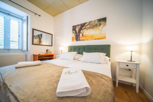 a bedroom with two beds with white sheets at Orgula in Lumbarda