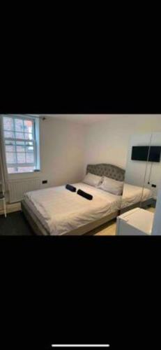 a bedroom with two beds and a window at Budget Central London room 3 in London