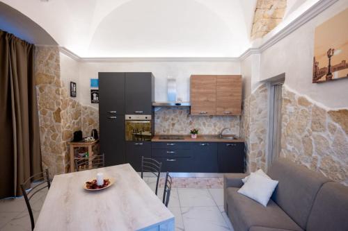 cocina y sala de estar con mesa y sofá. en maison27 en Bari
