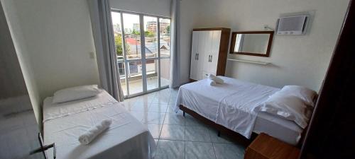 Ένα ή περισσότερα κρεβάτια σε δωμάτιο στο Casa Praia Itapema - 2 andares 3 quartos