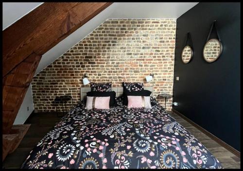 een slaapkamer met een groot bed in een bakstenen muur bij 06. Le New york Style By Fanny .S in Saint-Quentin