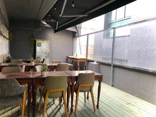 a restaurant with tables and chairs in a room at Bao Guesthouse in Seoul