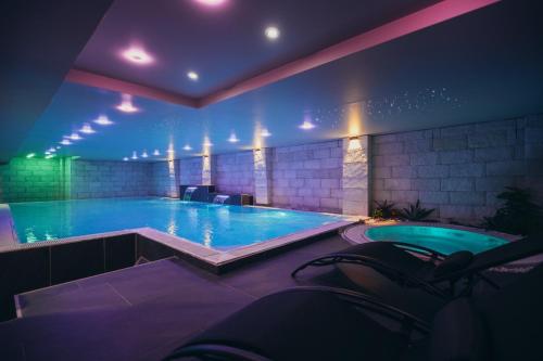 a large swimming pool in a building with aperature at Wellness Spa Hotel Jola in Banja Luka