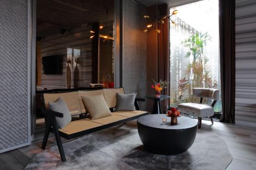 a living room with a couch and a table at Mulan Motel Taipei in Taipei