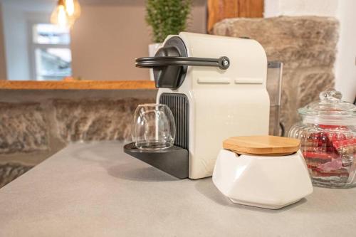 a kitchen counter with a coffee maker and a glass at Gemütliche Oase im Denkmal in Bönnigheim